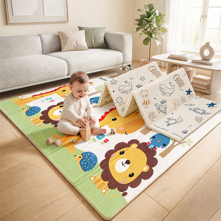 Baby playing on the Blessy double-sided foldable play mat with colourful animal and ocean designs