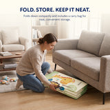 Parent folding the Blessy baby play mat for compact storage beside a living room sofa
