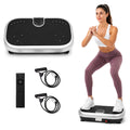 MotionGrey vibration plate with remote and resistance bands beside a woman doing a squat