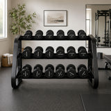 Loaded black three-tier dumbbell rack in a home gym