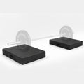 Pair of black MotionGrey weightlifting drop pads supporting a barbell