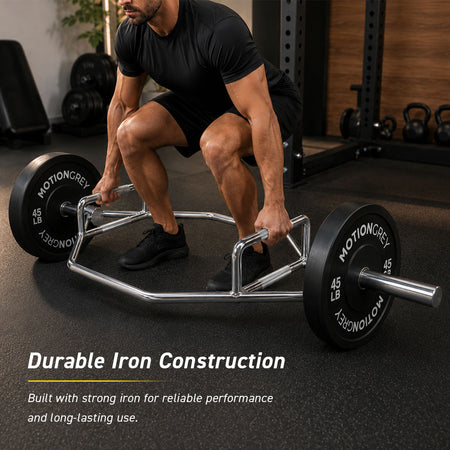Man performing a deadlift with a loaded silver trap bar