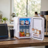 Open mini fridge storing meals and snacks on an office desk