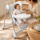 Caregiver feeding a baby seated securely in the gray adjustable high chair