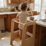 Toddler using the Blessy Baby Learning Tower at a kitchen counter
