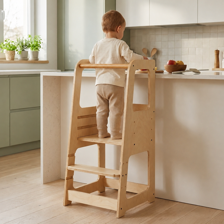 Child standing safely in the Blessy Baby Learning Tower in a modern kitchen