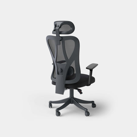Black ergonomic mesh office chair from a rear three-quarter angle