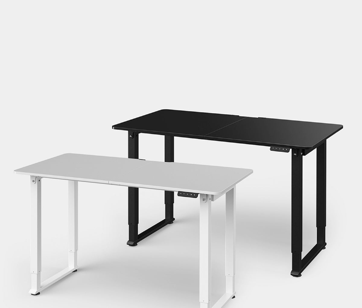 Electric standing desks in white and black