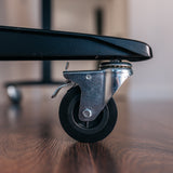 Close-up of a lockable table caster and brake lever