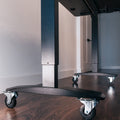 Lockable casters installed on a standing desk base