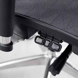 Close-up of the office chair under-seat tilt and adjustment controls
