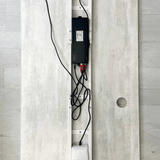 Animation showing loose desk cables gathered into an under-desk cable net