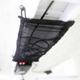 Black mesh cable net mounted beneath a white desk and holding cords