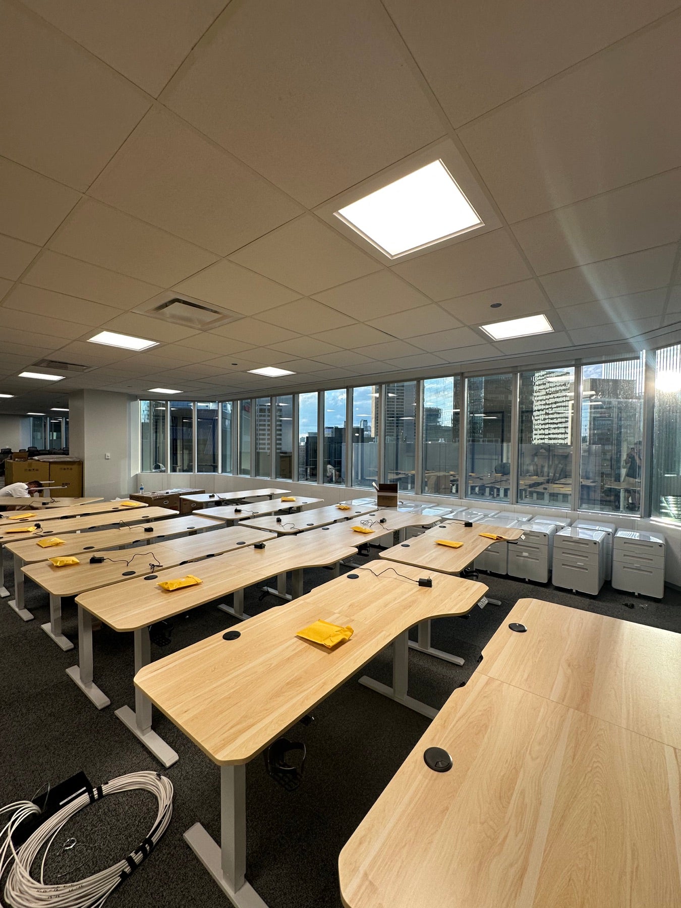 Ergo2 desks and white steel cabinets in the office during installation.