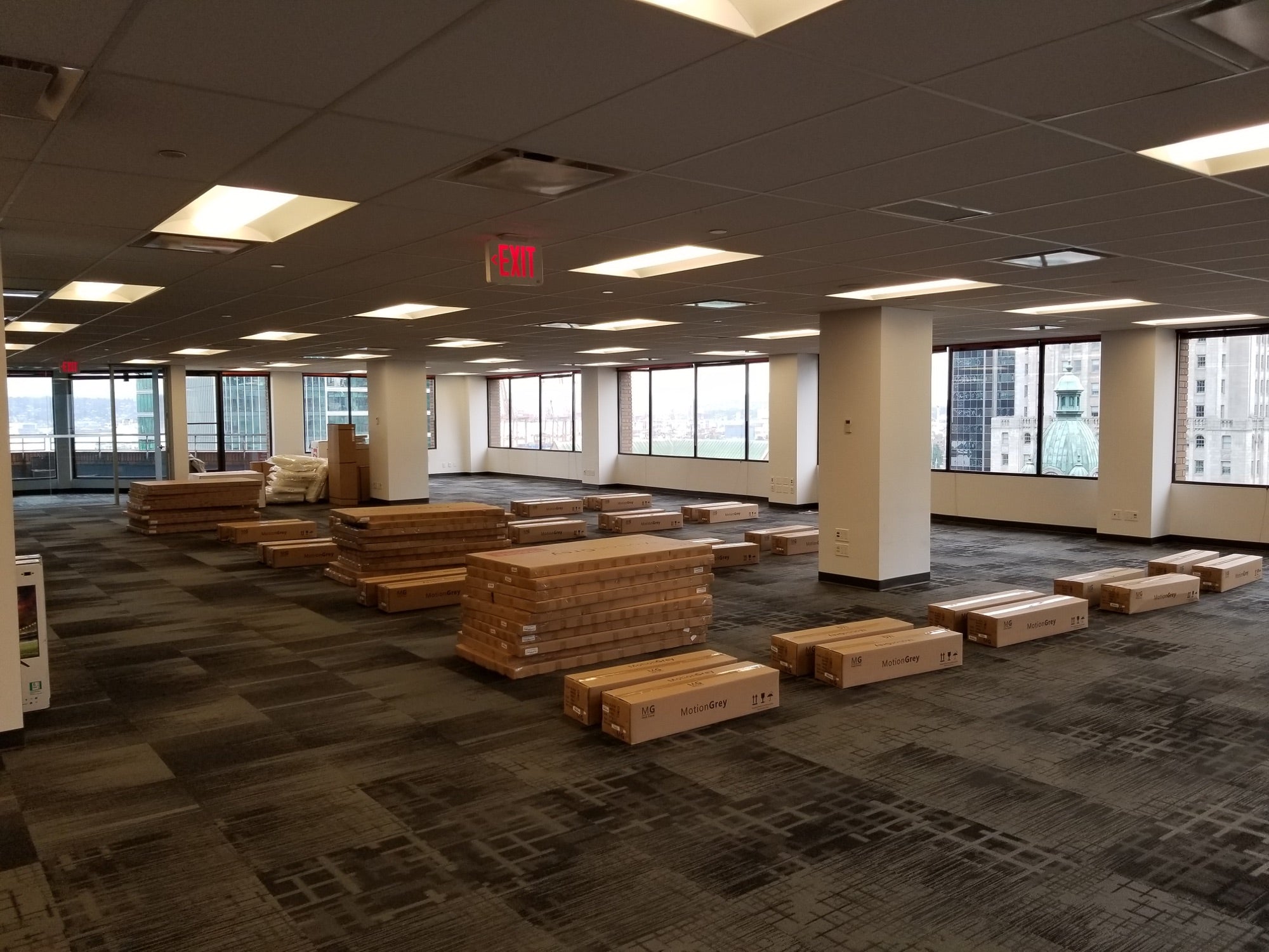 Cartons containing Motion Series standing desks unloaded and arranged inside MOJIO's Vancouver office before assembly.